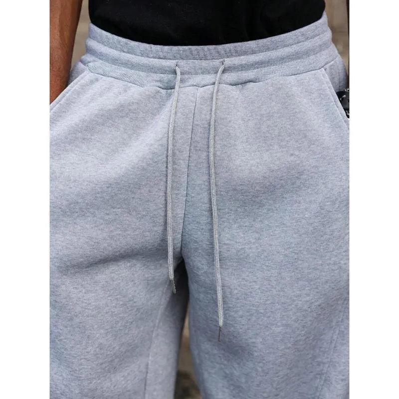 Men's dark grey high-waist straight-leg cropped casual trousers on a hanger.