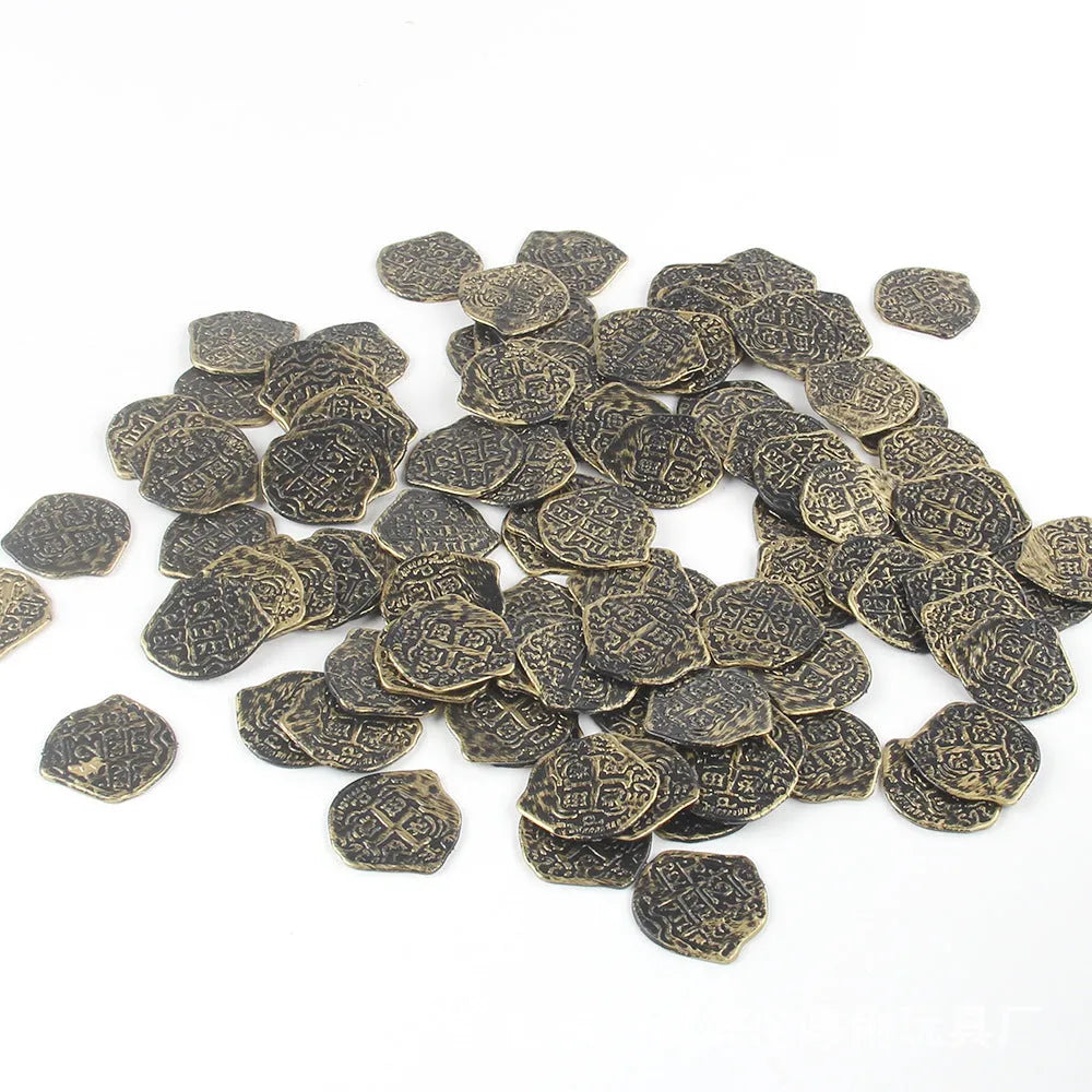 Close-up of detailed plastic Roman pirate coins in bronze, gold, and silver electroplated finishes.
