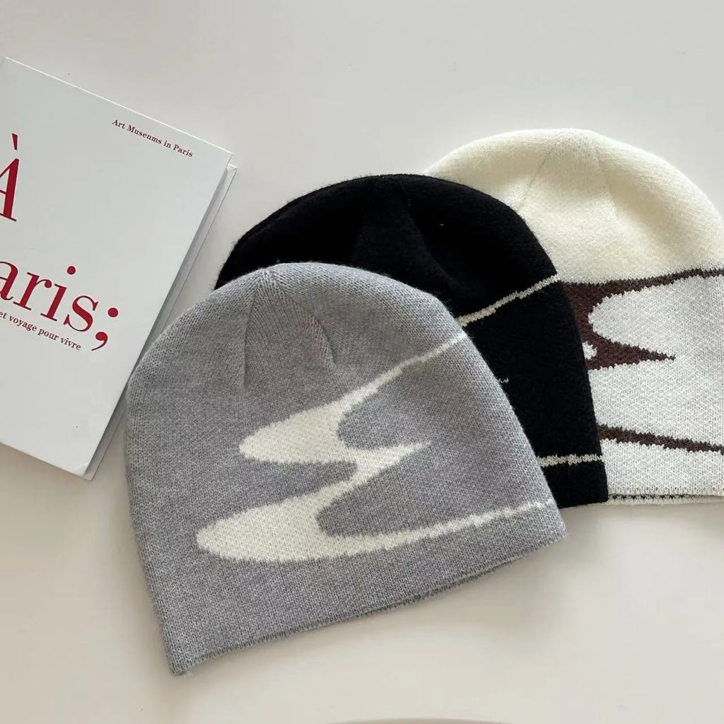 Acrylic thermal knit beanie hat in black, shown on a model, illustrating its textured anti-fall design.