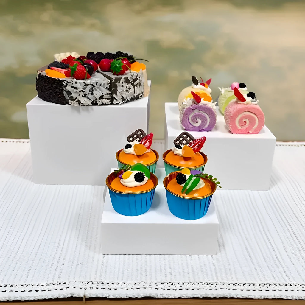 White plastic stackable dessert display stand with six pieces arranged in tiered formation
