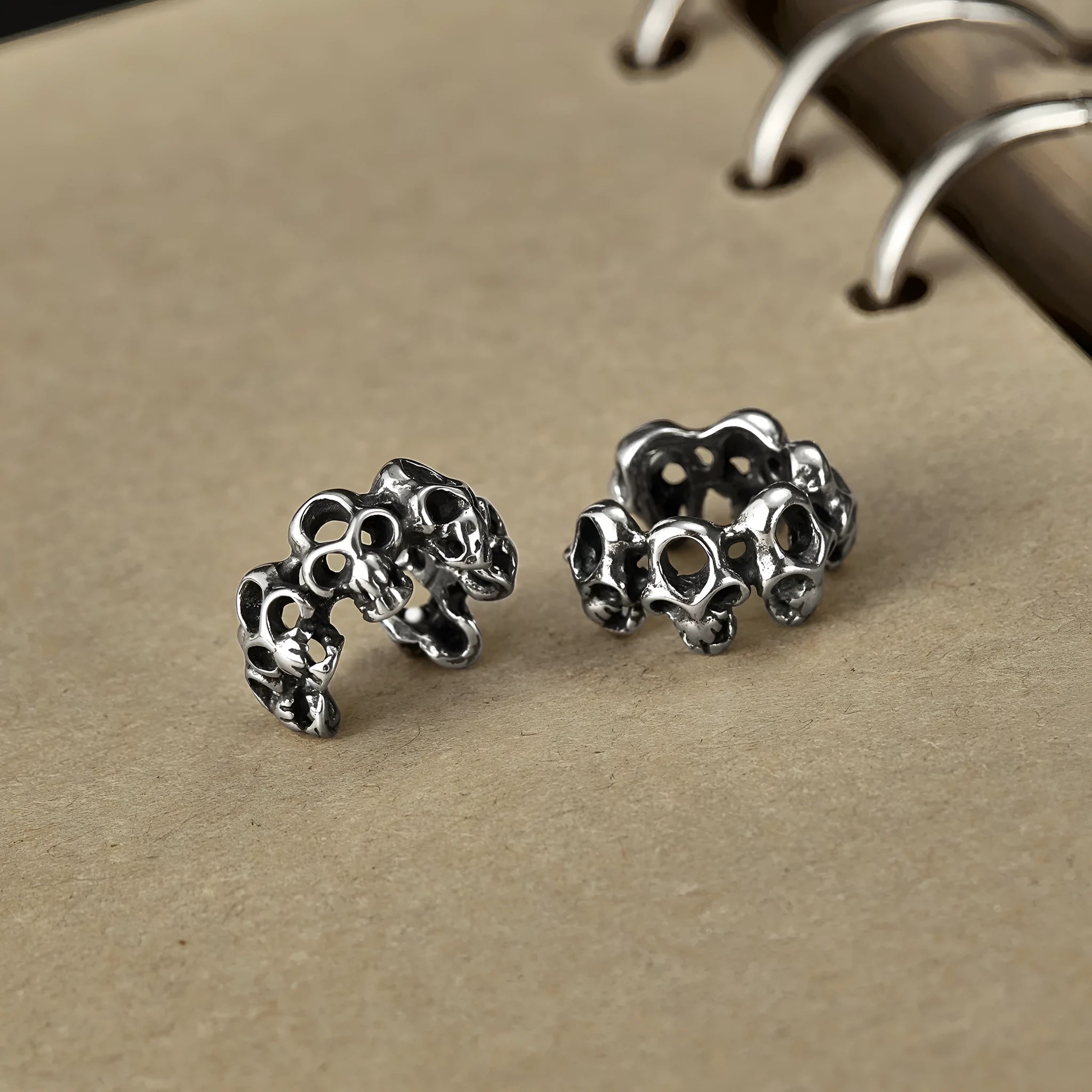 Stainless steel hollow skull earrings with clip backing in retro geometric design