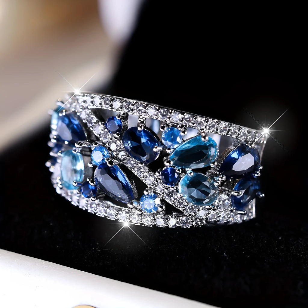 Women's round hollow copper fashion ring with simulated gemstones in gold or platinum plating options