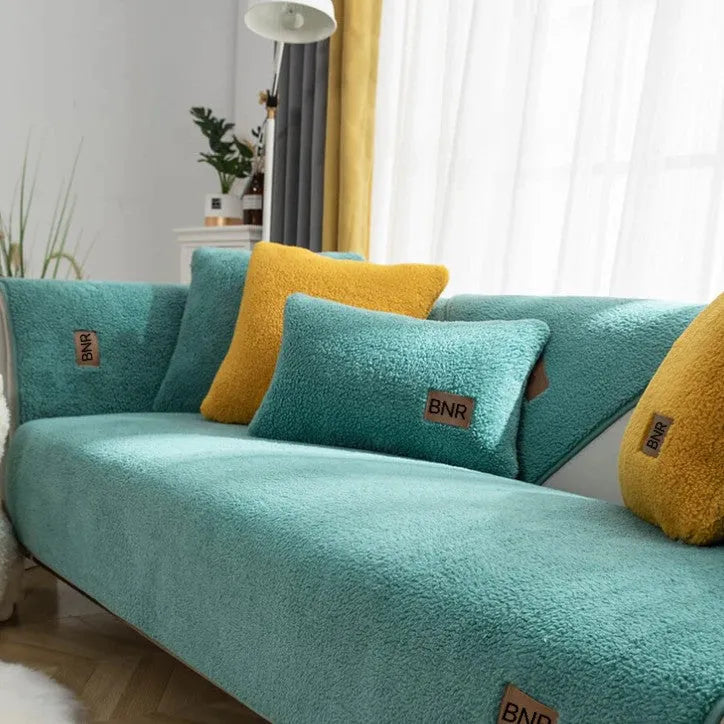 Lambswool solid colour sofa cover in blue on a three-seater sofa