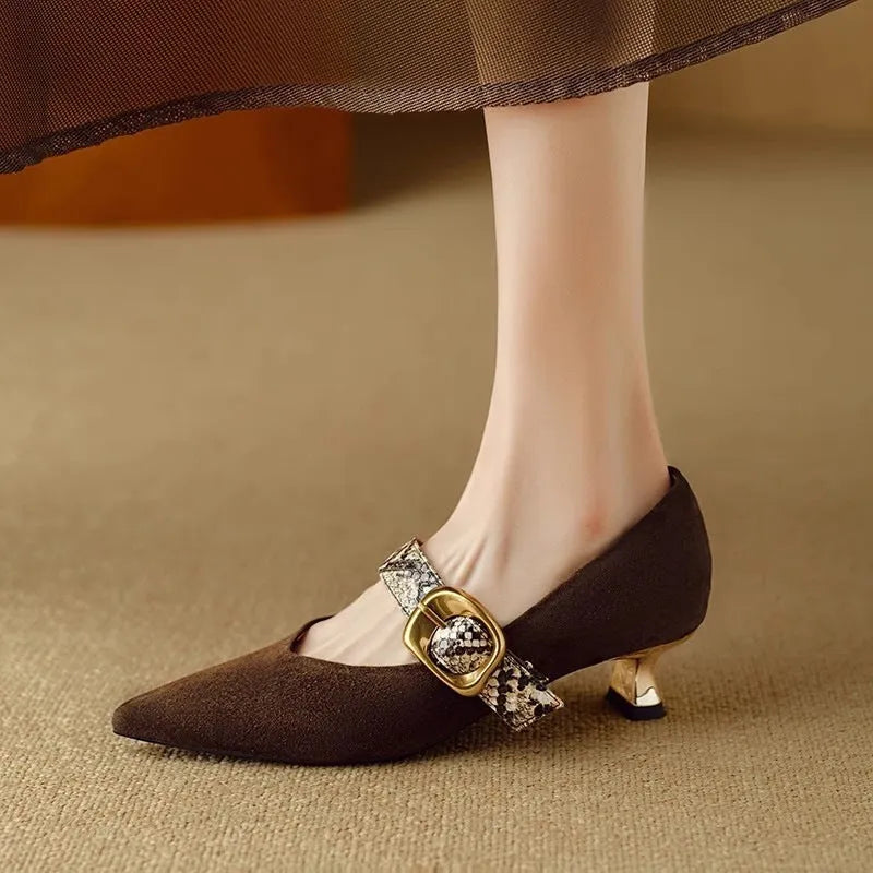 Black pointed-toe stiletto heels with a buckle fastening on the low-cut upper