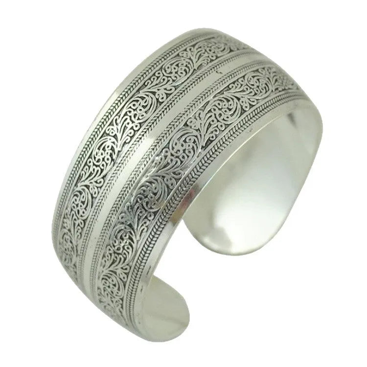 Ethnic carved Miao silver style alloy bracelet in open design with turtle or elephant colour motifs