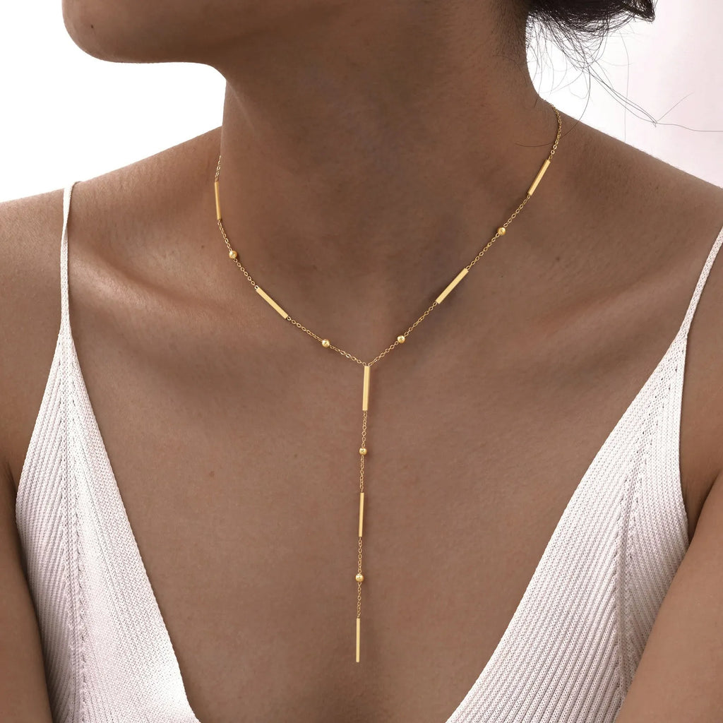 Women's stainless steel gold electroplated geometric pendant necklace on display