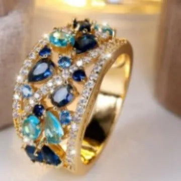 Women's round hollow copper fashion ring with simulated gemstones in gold or platinum plating options