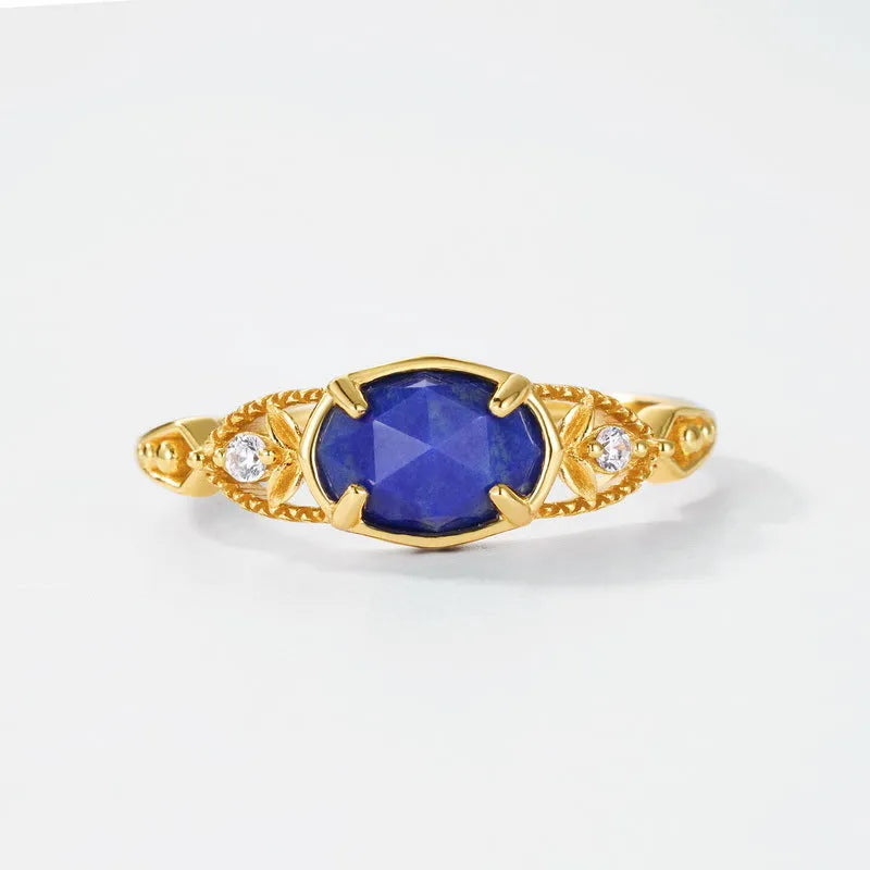 Women's oval geometric ring with blue lapis lazuli stone on a silver-coloured alloy band.
