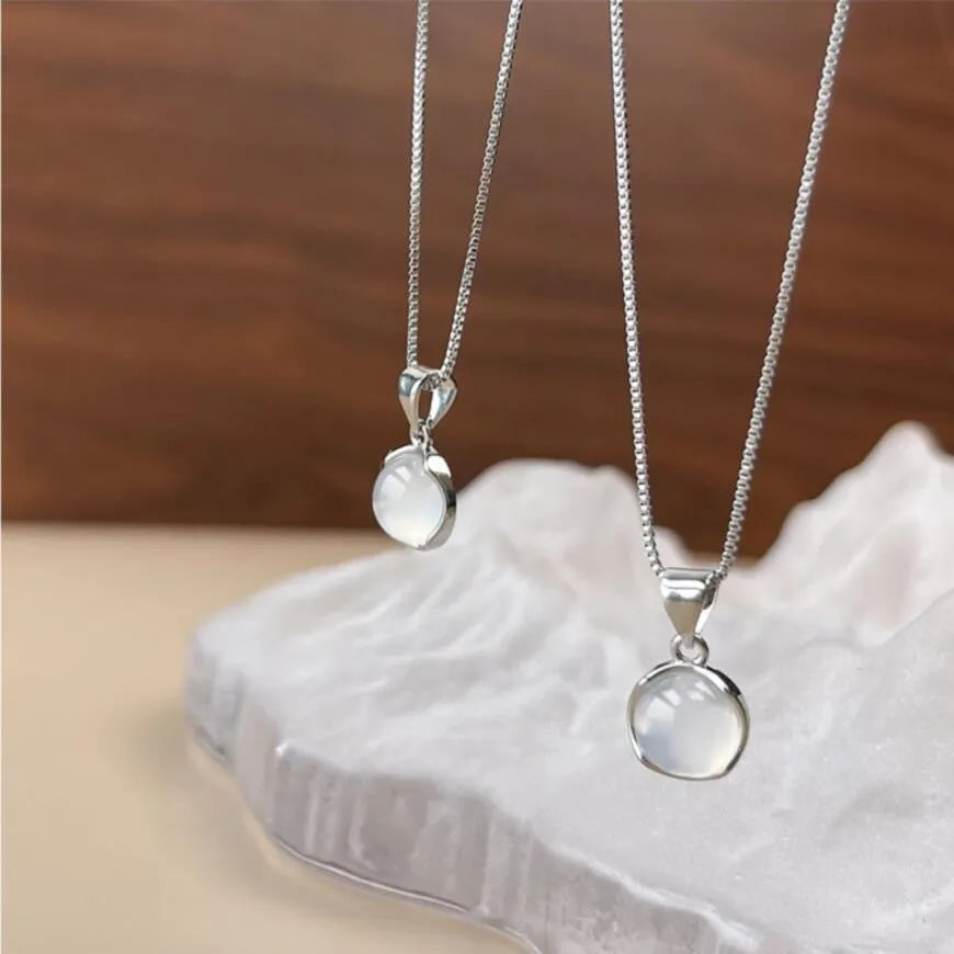 Women's oval geometric pendant necklace with eight awn star crystal on an adjustable box chain.
