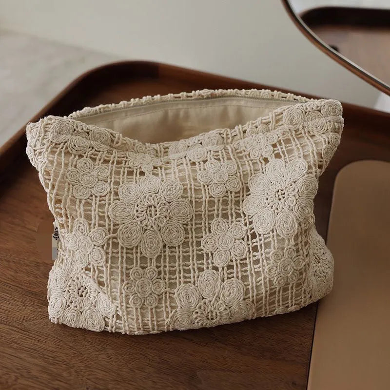 Handmade crocheted cosmetic bag with floral embroidery on corduroy fabric and rope drawstring