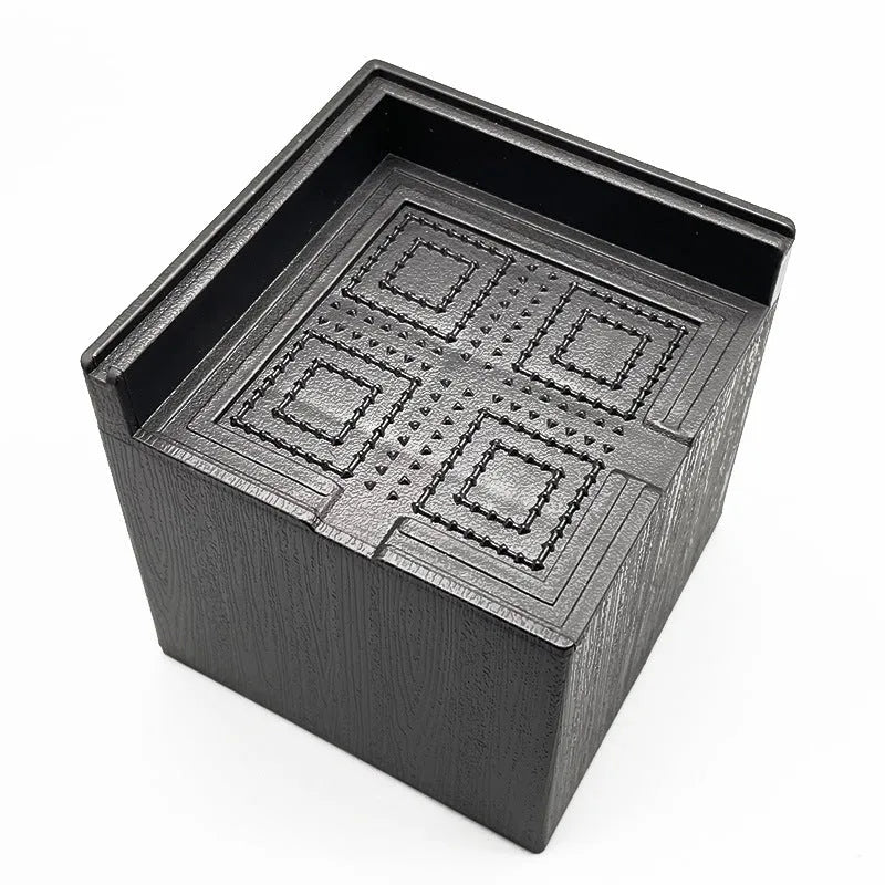 Four black plastic furniture height adjustment mats for sofa or bed feet.