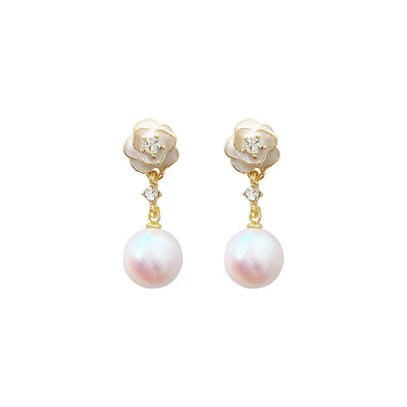 Close-up of women's camellia pearl flower stud earrings in alloy with butterfly clasp