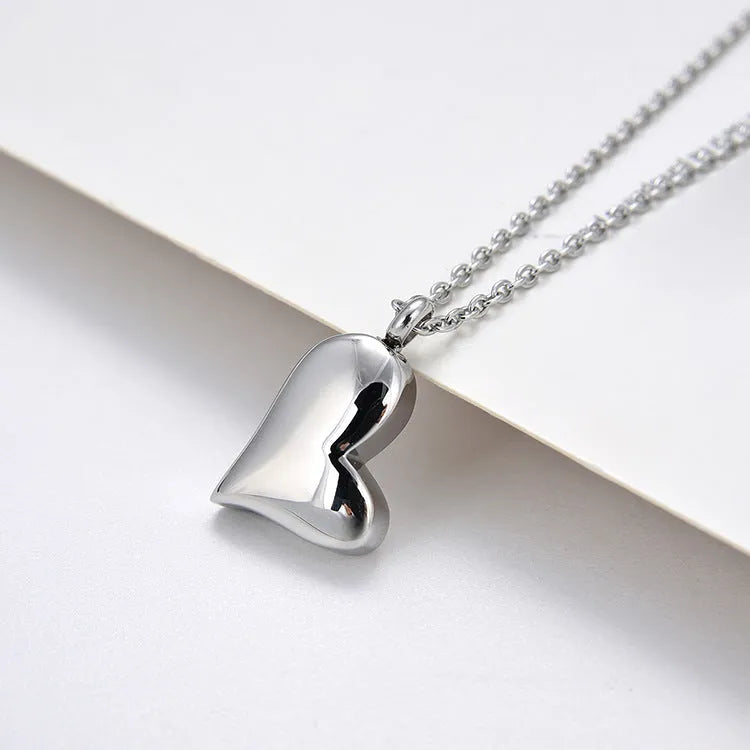 Silver curved peach heart stainless steel pendant necklace on a chain
