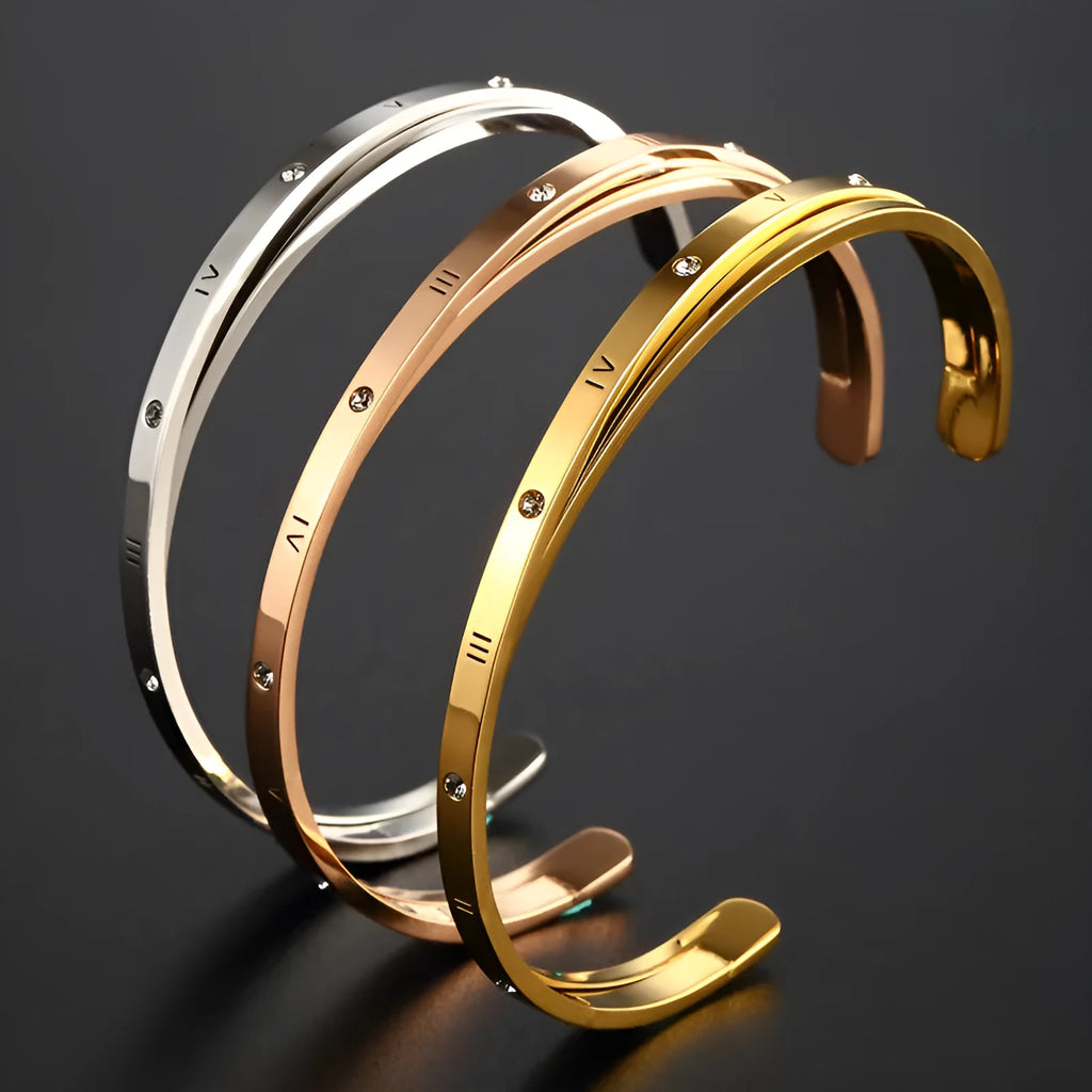 Open-ended stainless steel bracelet with zircon stones in gold, rose, or silver colour on a wrist.
