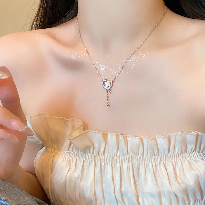 Women's gold star and moon zirconium necklace on an adjustable chain.