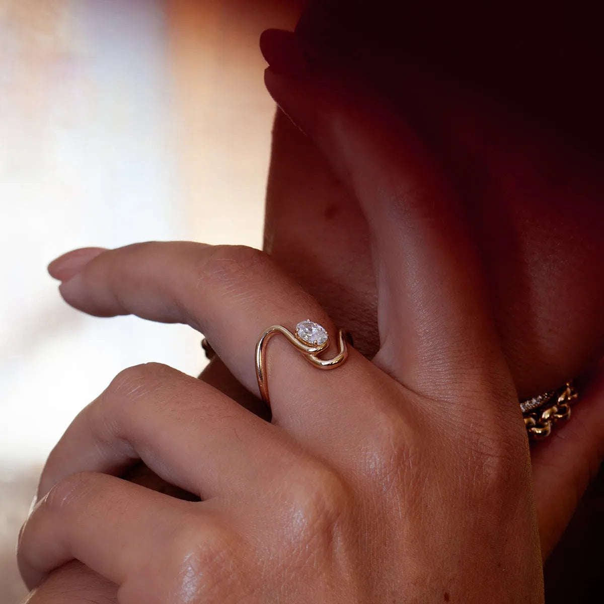 Geometric cut zircon stone set in a titanium steel ring on a grey background.