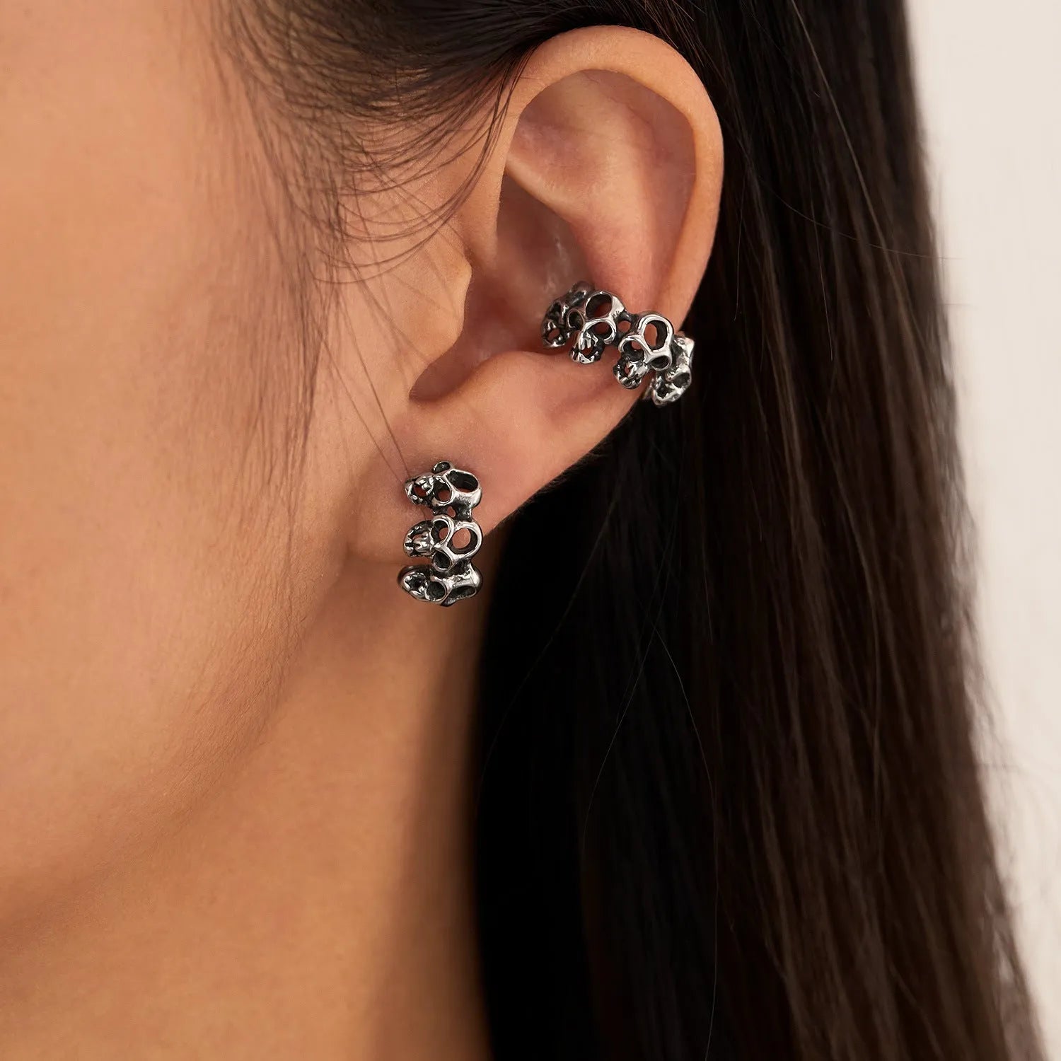 Stainless steel hollow skull earrings with clip backing in retro geometric design