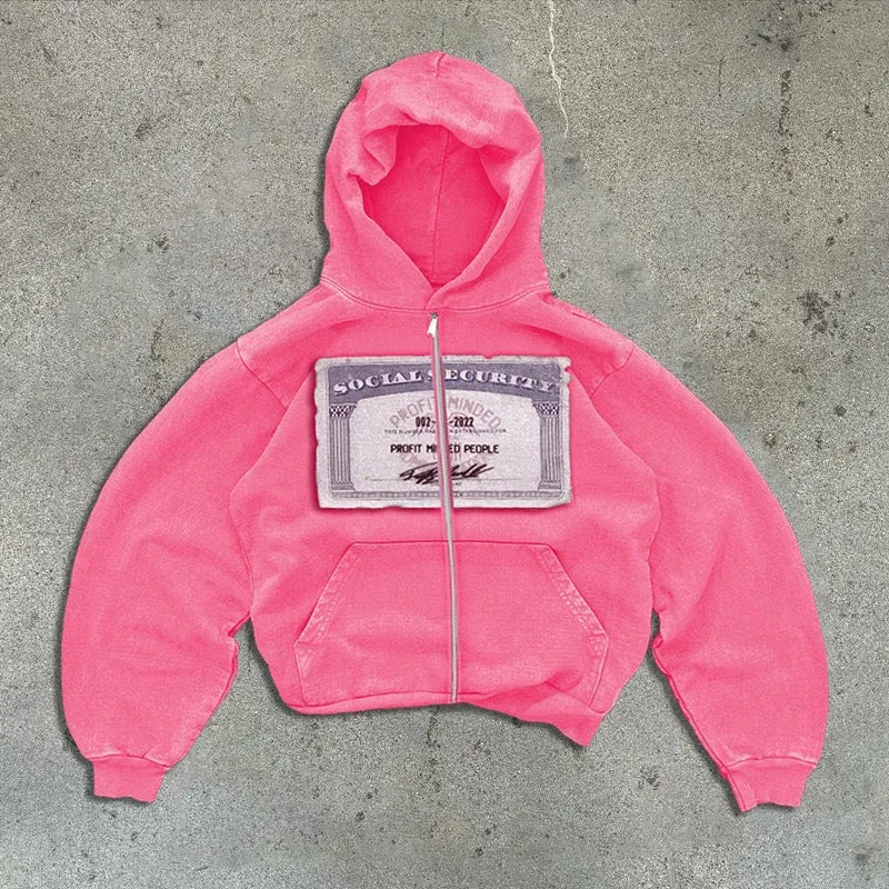 A person wearing a black unisex loose-fit hooded zip-up jacket with a letter pattern and zippered pockets.