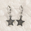 Women's alloy crystal earrings showing five colour options: white cross, white peach heart, white cross, black cat, and antique silver star design.
