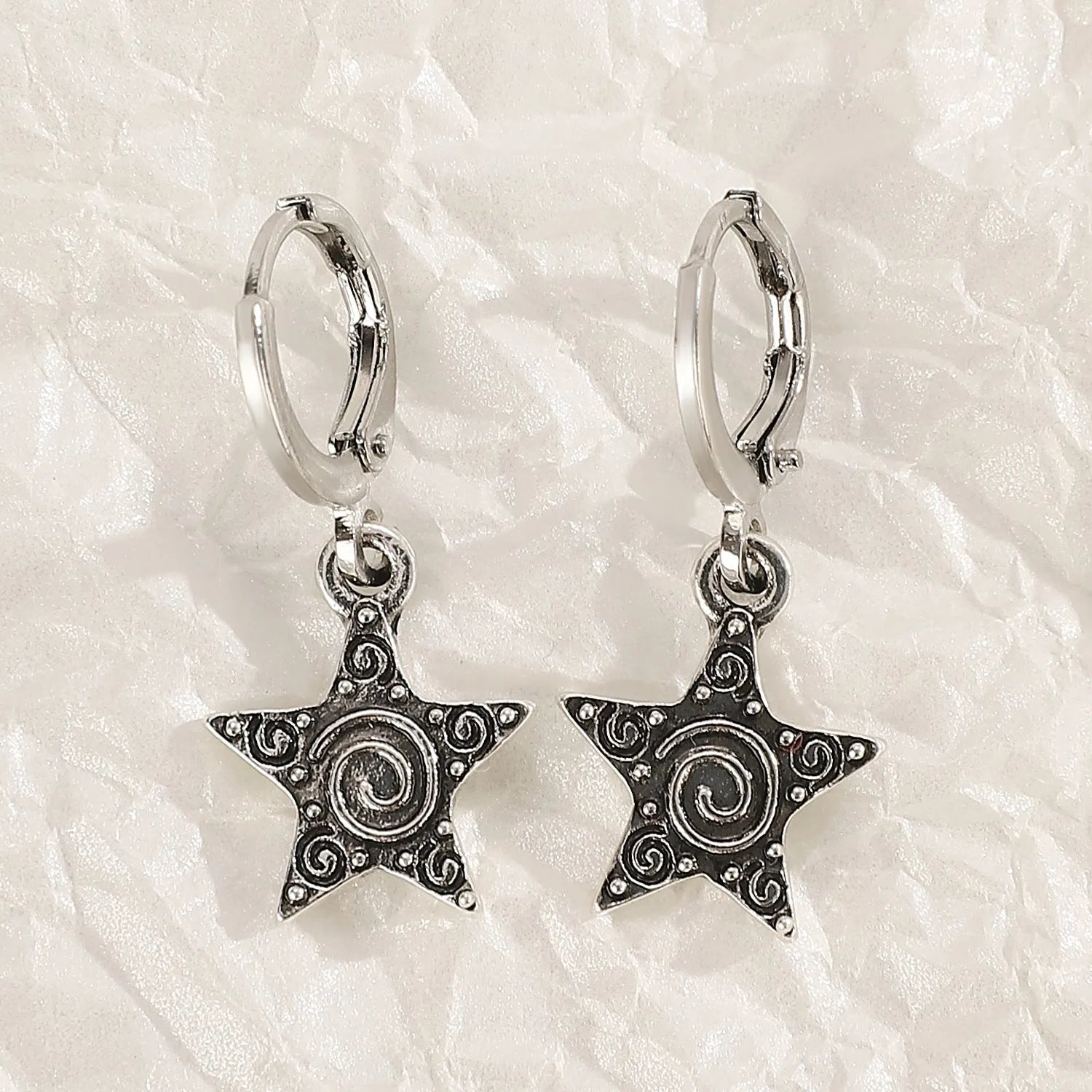 Women's alloy crystal earrings showing five colour options: white cross, white peach heart, white cross, black cat, and antique silver star design.