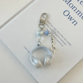 Creative music headset keychain with gradient blue resin earphone pendant and alloy keyring on a plain background