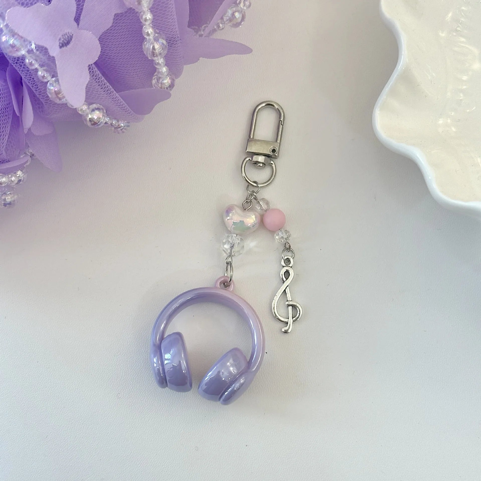 Creative music headset keychain with gradient blue resin earphone pendant and alloy keyring on a plain background