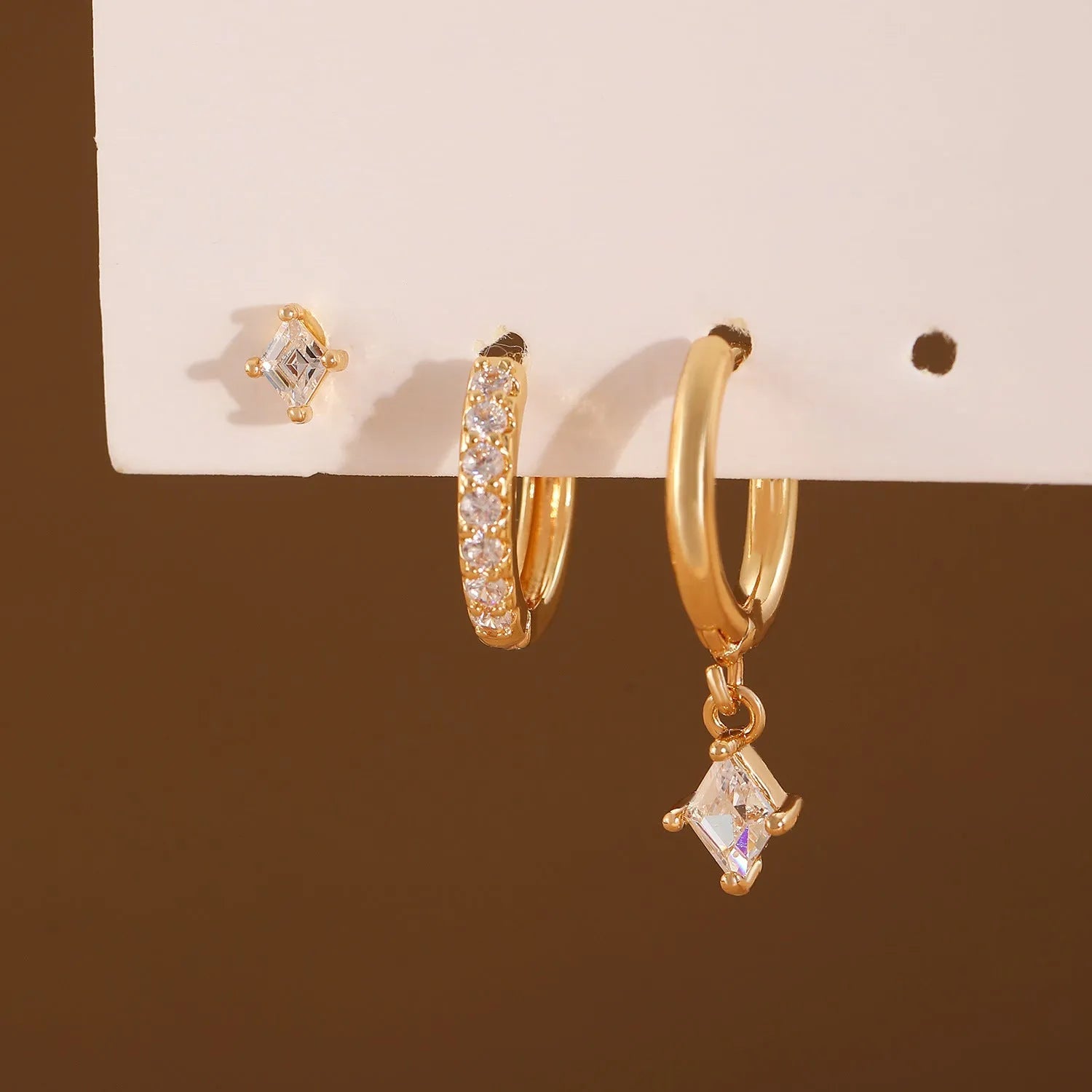 Ladies three-piece ear jewellery set with geometric diamond shapes and inlaid zircon stones in gold and white colours