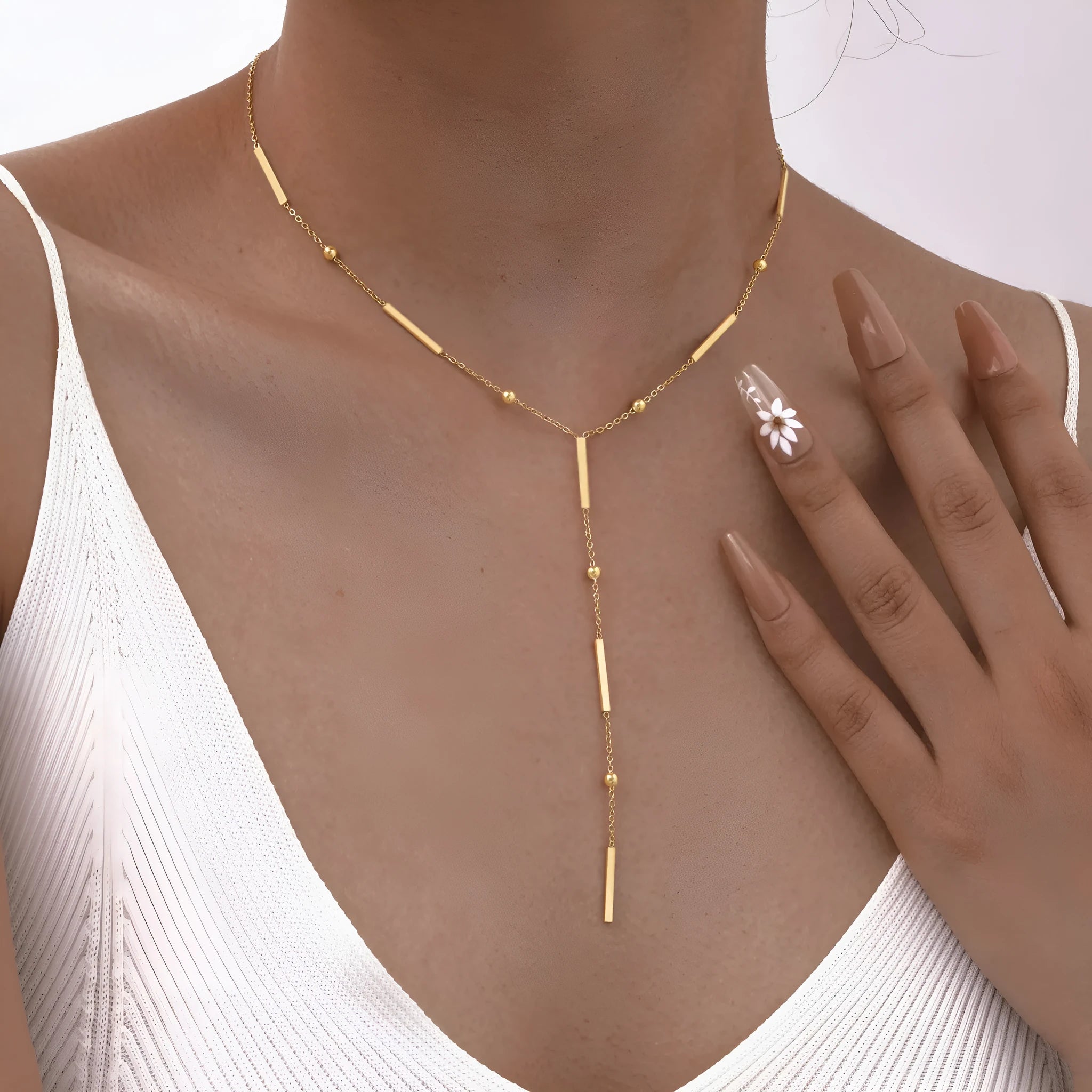 Women's stainless steel gold electroplated geometric pendant necklace on display