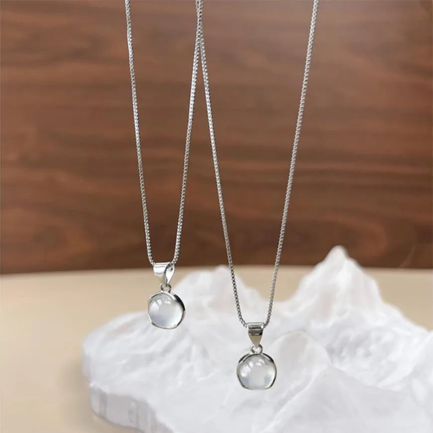 Women's oval geometric pendant necklace with eight awn star crystal on an adjustable box chain.