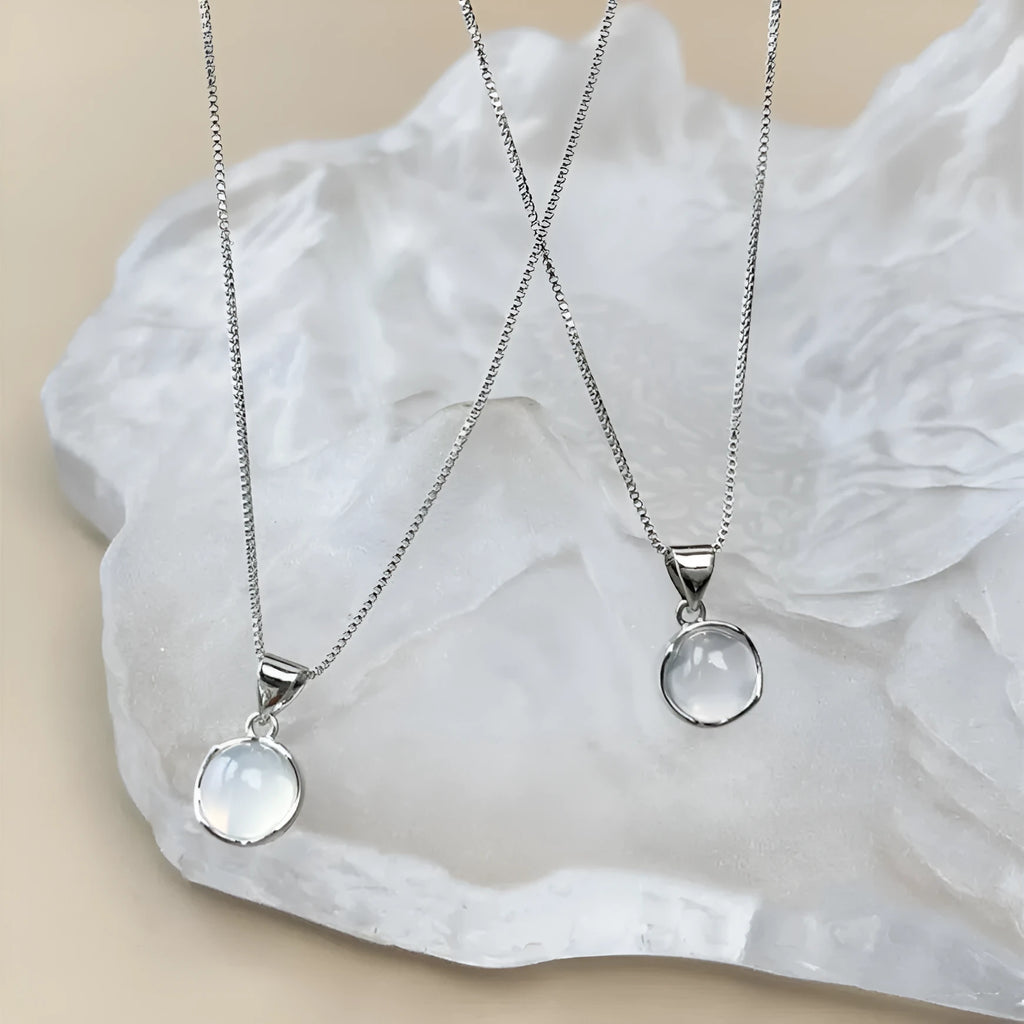 Women's oval geometric pendant necklace with eight awn star crystal on an adjustable box chain.
