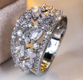 Women's round hollow copper fashion ring with simulated gemstones in gold or platinum plating options