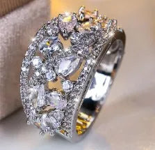Women's round hollow copper fashion ring with simulated gemstones in gold or platinum plating options