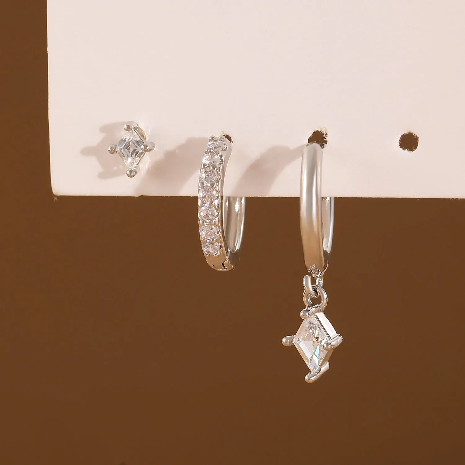 Ladies three-piece ear jewellery set with geometric diamond shapes and inlaid zircon stones in gold and white colours