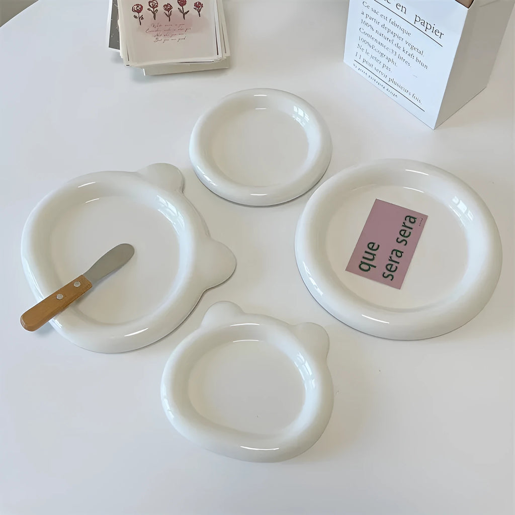 White ceramic plate with chubby bear or round toot design, shown in 15cm and 20cm sizes as a plant tray.