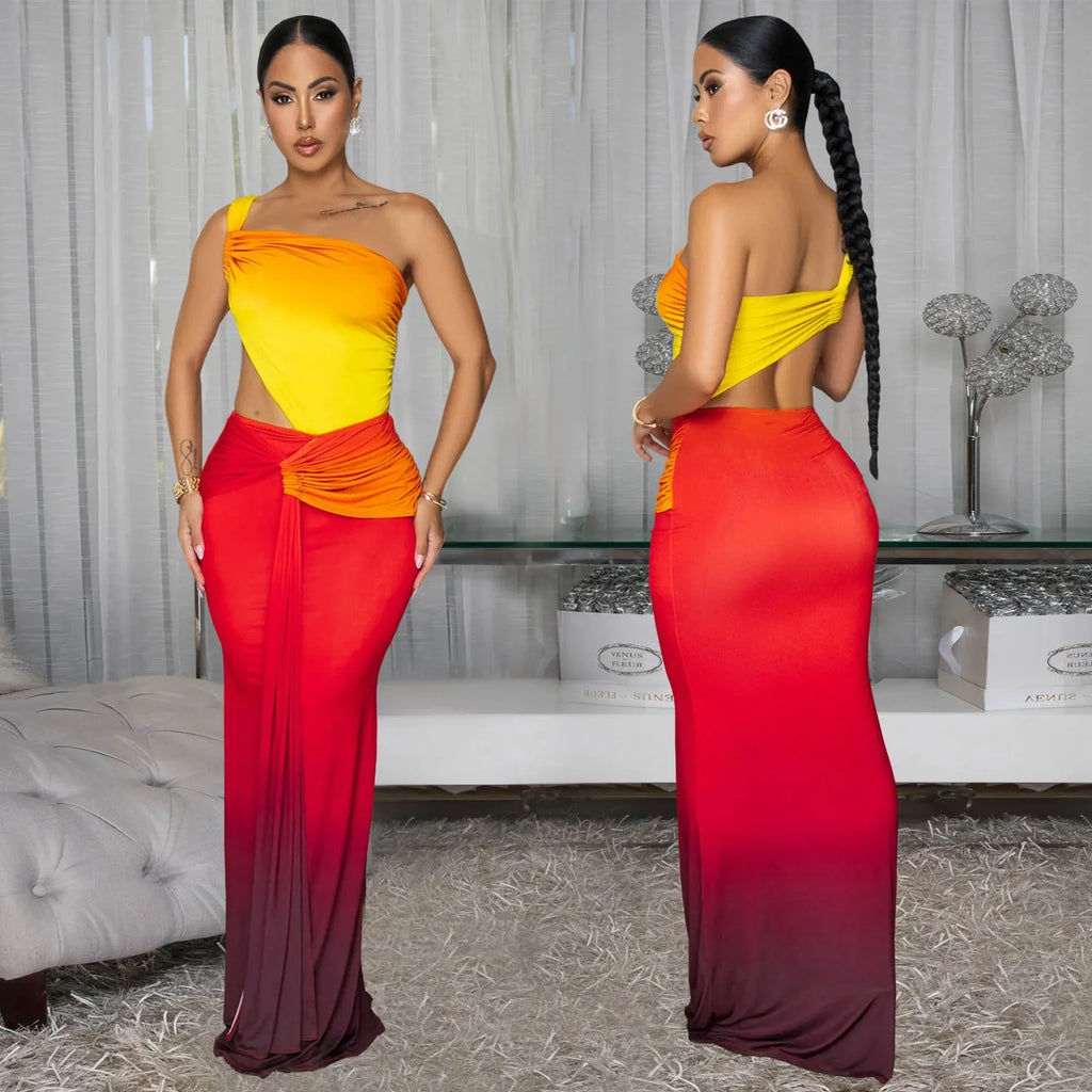 A woman's long gradient dress with a cross-shoulder neckline and high waist, shown in a colour option.