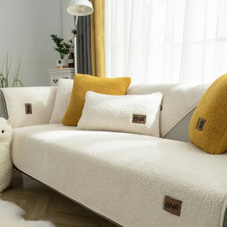 Lambswool solid colour sofa cover in blue on a three-seater sofa
