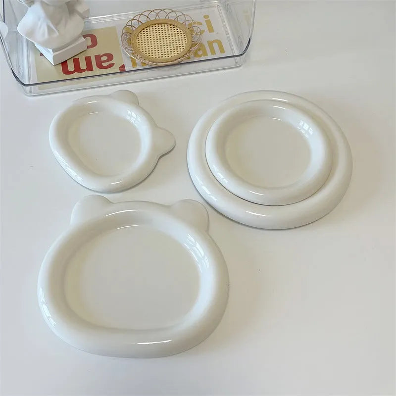 White ceramic plate with chubby bear or round toot design, shown in 15cm and 20cm sizes as a plant tray.