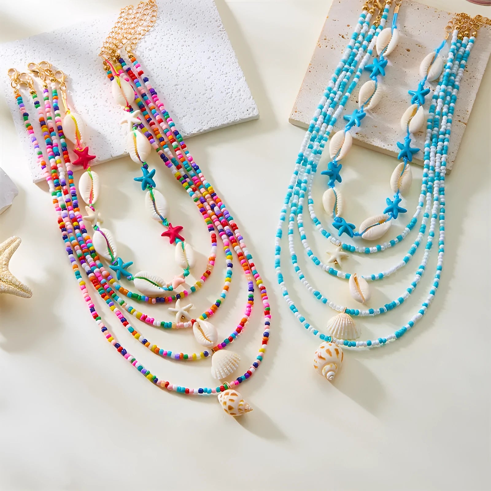 Blue multi-layer women's necklace set with starfish, shell, and conch bead pendants on bead chains