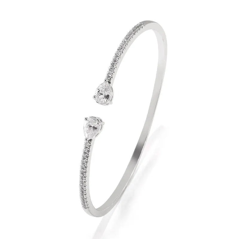 Copper bracelet with inlaid zircon stones in a simple design, shown in white and blue colour options.