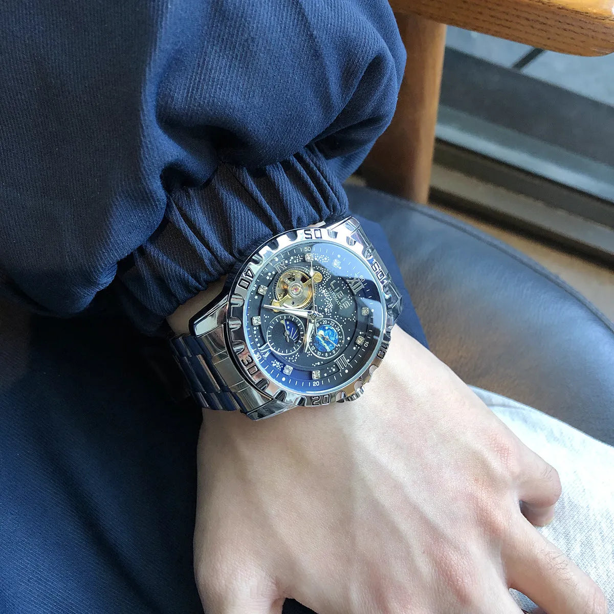Men's silver automatic mechanical watch with black steel belt, 12mm case, and luminous starry dial