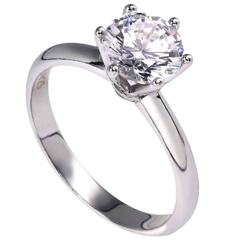 White gold plated women's ring with six-claw cubic zirconia setting on geometry shaped band