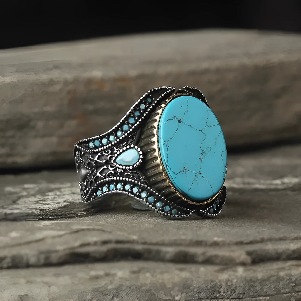 Men's turquoise alloy ring with antique silver finish showing round band design