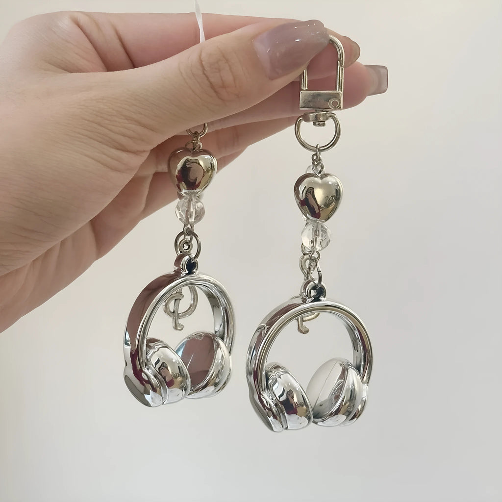 Creative music headset keychain with gradient blue resin earphone pendant and alloy keyring on a plain background
