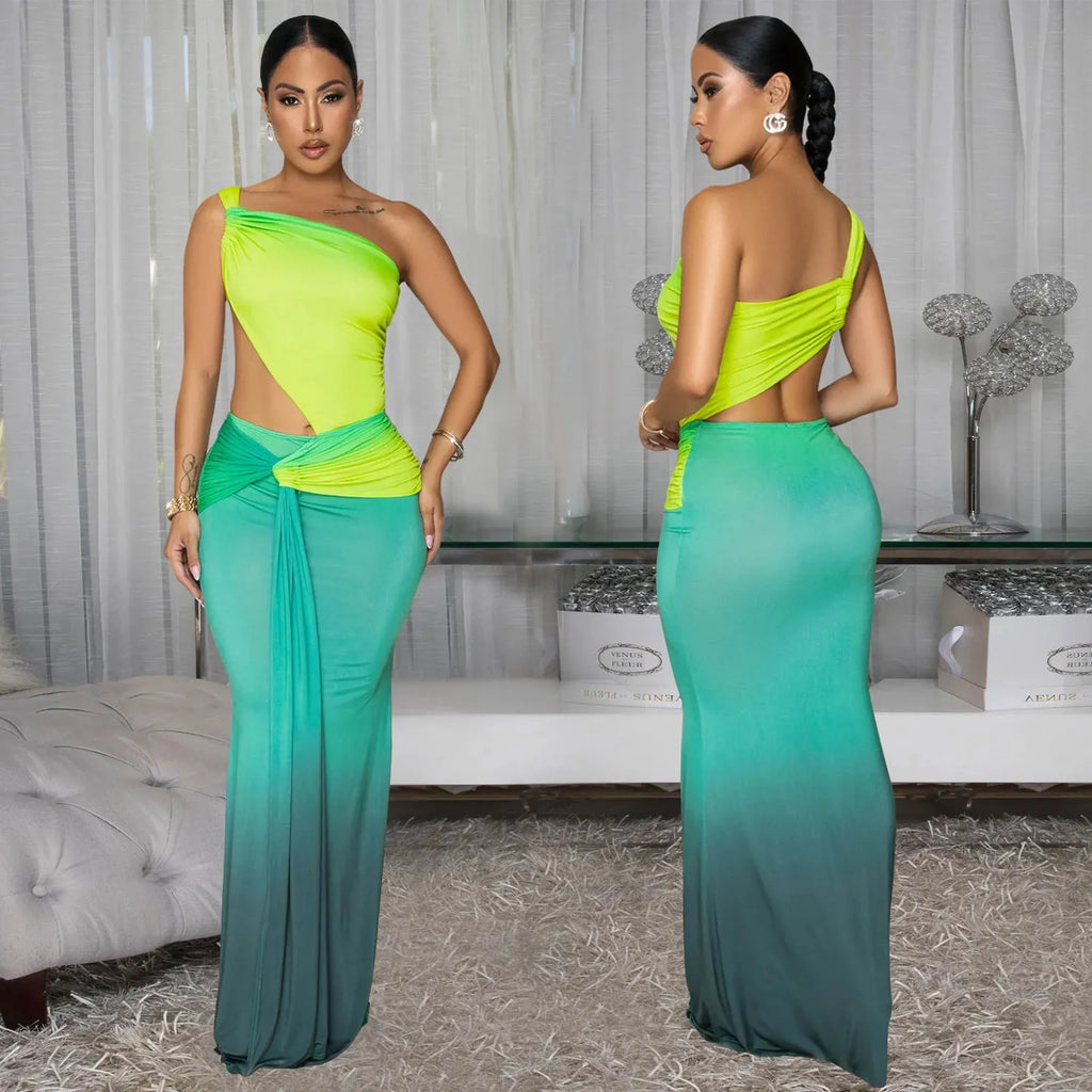 A woman's long gradient dress with a cross-shoulder neckline and high waist, shown in a colour option.