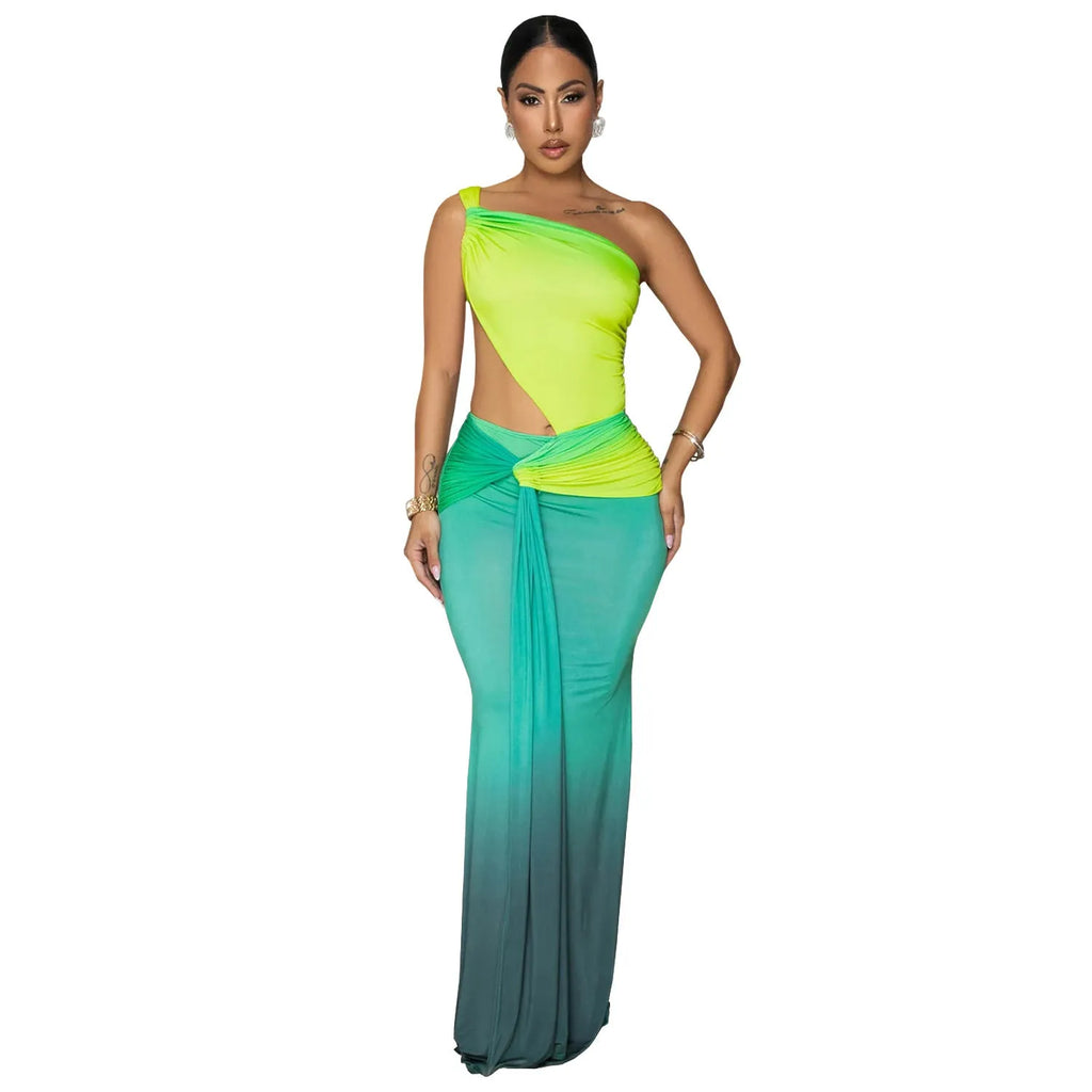 A woman's long gradient dress with a cross-shoulder neckline and high waist, shown in a colour option.