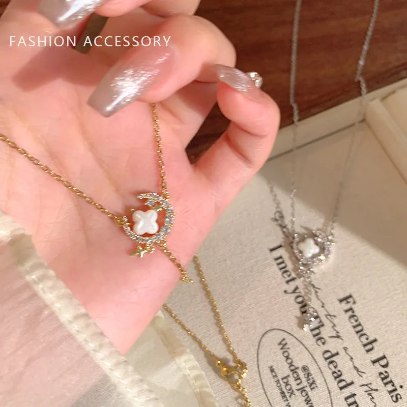 Women's gold star and moon zirconium necklace on an adjustable chain.