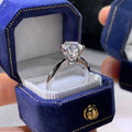 White gold plated women's ring with six-claw cubic zirconia setting on geometry shaped band