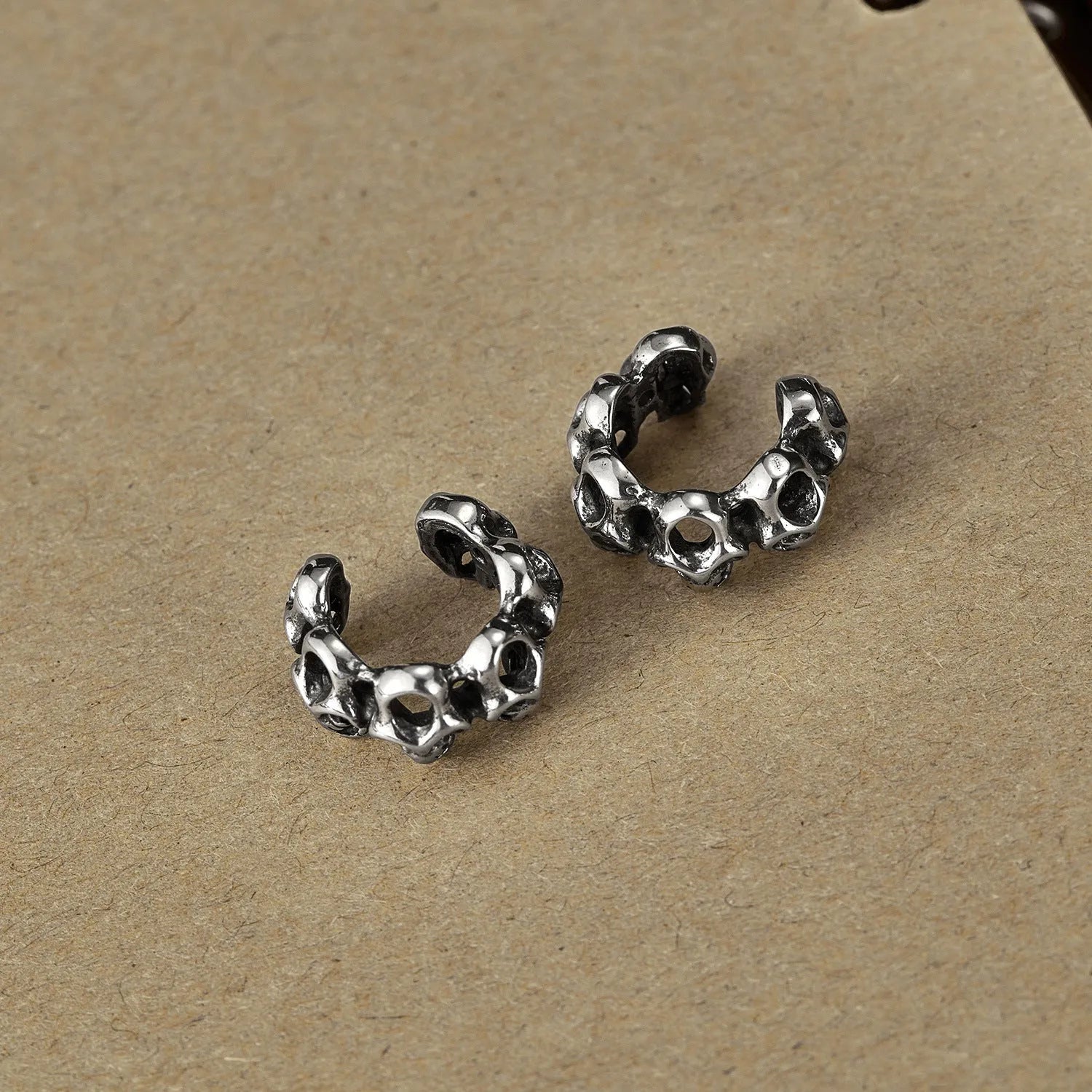 Stainless steel hollow skull earrings with clip backing in retro geometric design