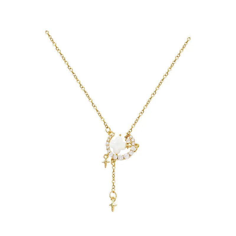 Women's gold star and moon zirconium necklace on an adjustable chain.
