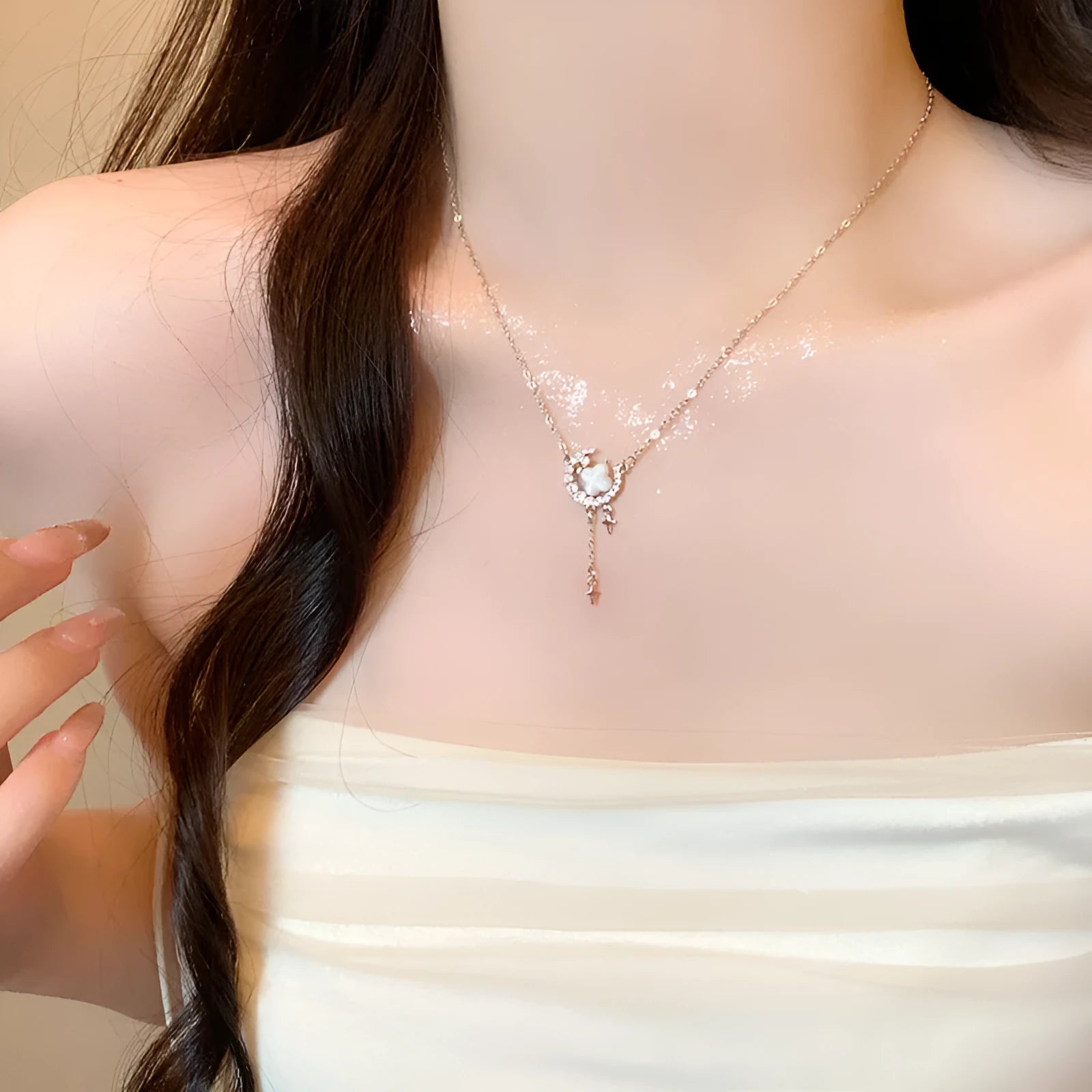 Women's gold star and moon zirconium necklace on an adjustable chain.